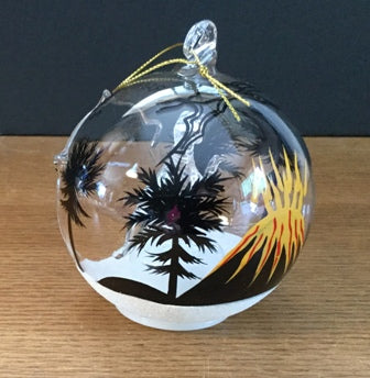 Colour changing LED Christmas ornament featuring the fearsome Tyrannosaurs Rex. Photos show unlit ornament and various colours of the LED light, plus the rear of the bulb which shows a volcano in a Prehistoric scene.